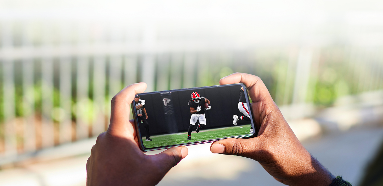 phone featuring Bijan Robinson playing football