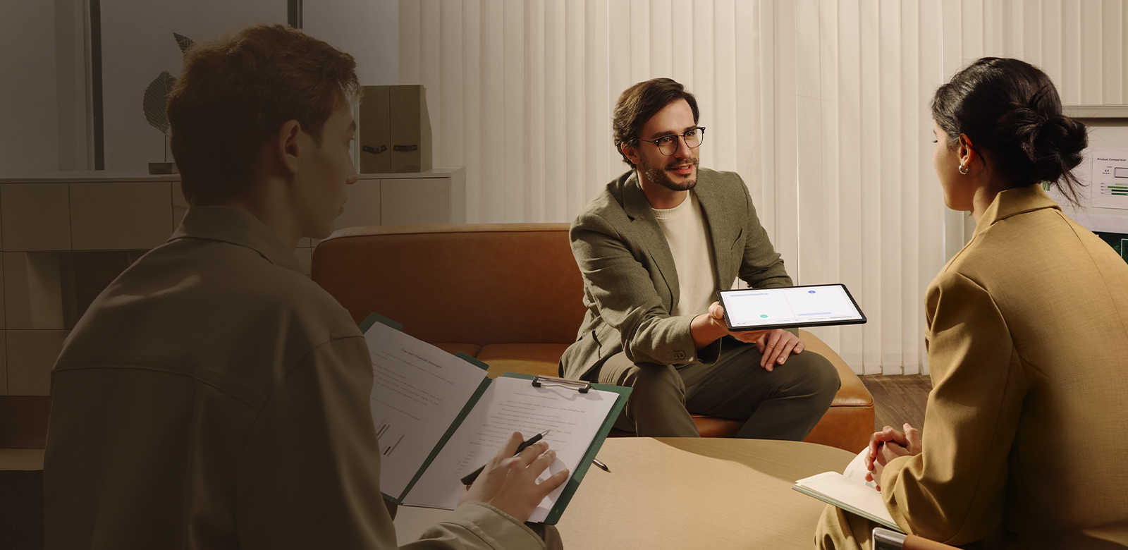 colleagues in meeting using tablet AI and multitasking